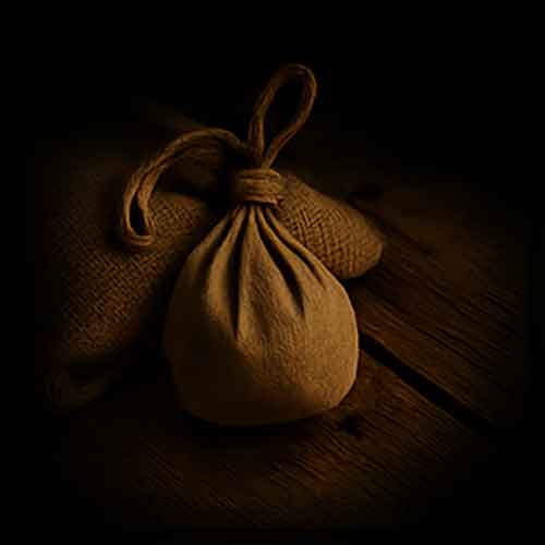 Brown burlap bindle on a dark wooden surface